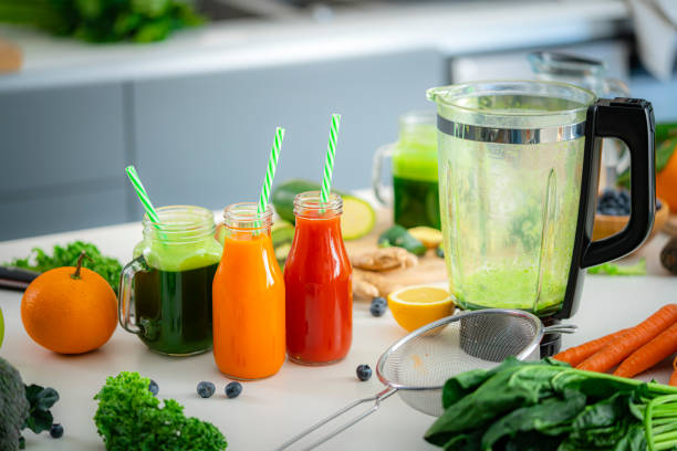 istock Healthy blended fruits and vegetables detox drinks on kitchen table 1472582547