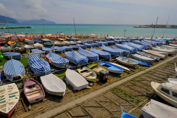 many colorful boats on the shore across the seaside view in Lavagna, Liguria, Italy. Coast view many colorful boats on the shore across the seaside view in Lavagna, Liguria, Italy. Coast view lavagna stock pictures, royalty-free photos & images
