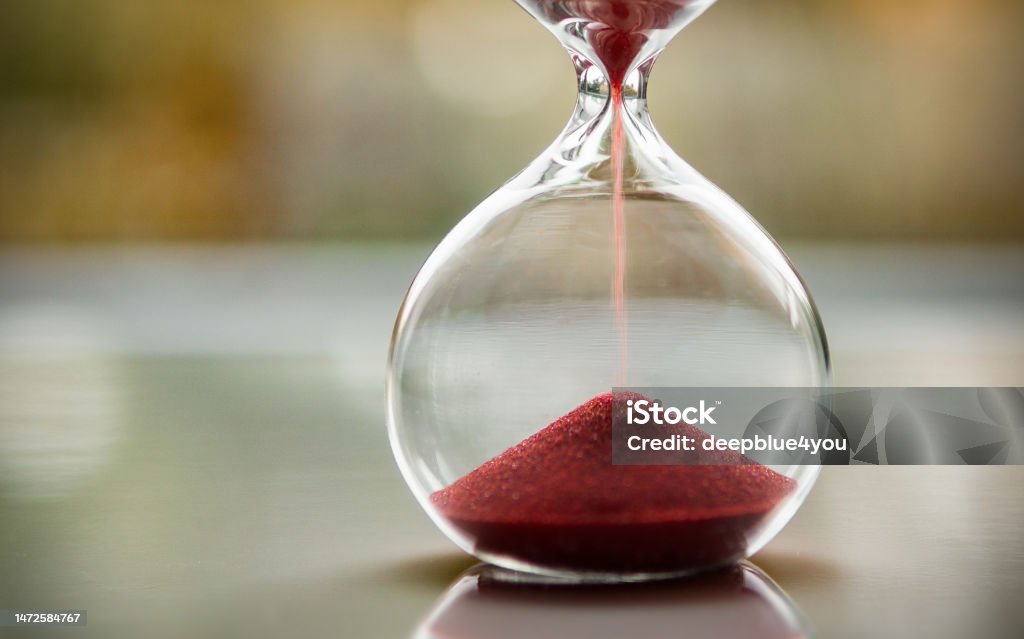 Red Sand Flows Through The Oldfashioned Hourglass Stock Photo ...