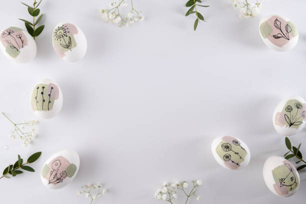 istock Modern hand painted easter egg on white background. Happy easter poster and banner for greeting text. Top view 1472585651