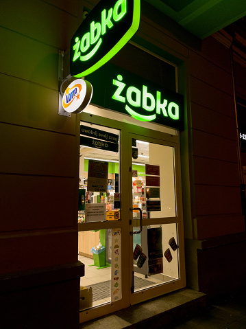 Warsaw, Poland - March 03, 2023: Zabka store in the center of Warsaw at night. Zabka is a chain of small stores.