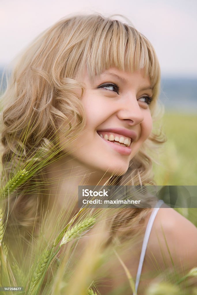 Attractive smiling girl outside Attractive smiling girl outside in green grass Adult Stock Photo