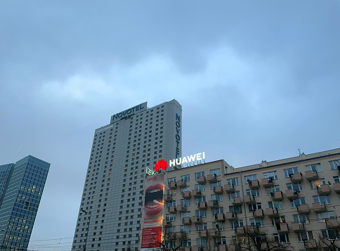 Warsaw, Poland - March 03, 2023: Novotel and Huawei advertise on high-rise buildings.