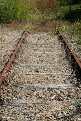End of a line of train rail tracks symbolizing the end of the road, the finish, the end of the track.