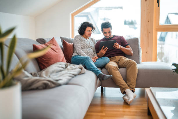 istock Hispanic And Black Pregnant Couple Using A Digital Tablet 1472588005