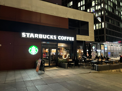 Warsaw, Poland - March 03, 2023: Starbucks coffee chain cafe coffeehouse near city center in Warszawa at night