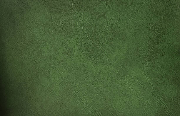 istock close up green olive leather texture used as background for design. abstract vintage background template. genuine leather upolstery for cloth wearing. 1472590628