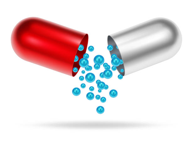 istock Open medicine capsule. Medical pill. Half parts with cure granules 1472590916