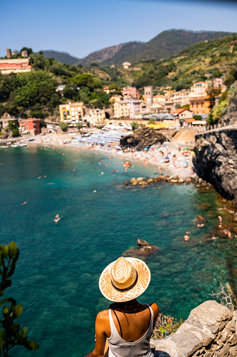 Female tourist enjoying beautiful view to Monterosso village at Cinque Terre, Italy