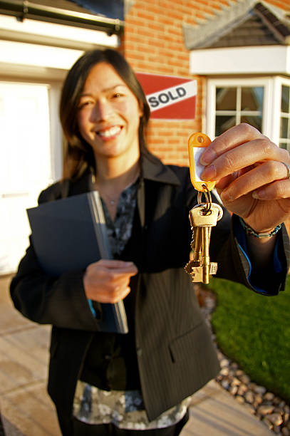 istock Female realestate agent holding keys 147259180