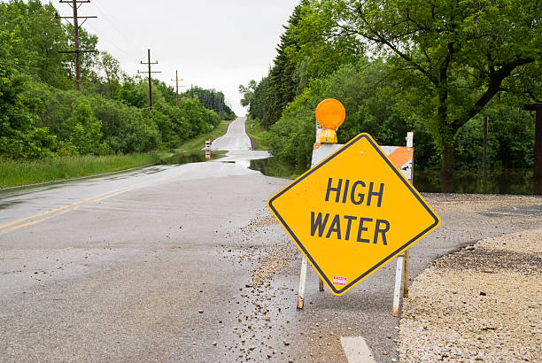 istock Yellow high water sign on a wet road 147259235