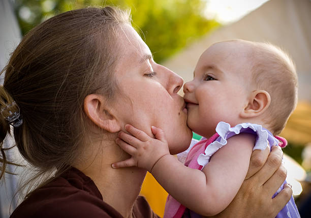 istock Mother kissing her baby 147259268