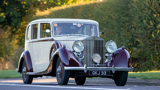 Bicester,Oxon,UK - Oct 9th 2022. 1939 cream Rolls Royce driving on an English country road