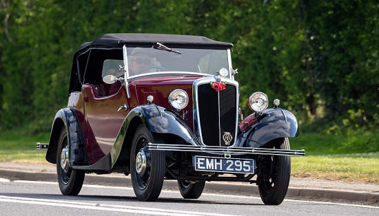 Bicester, Oxon., UK - April 24th 2022. 1936 885 cc Morris vintage car driving on an English country road