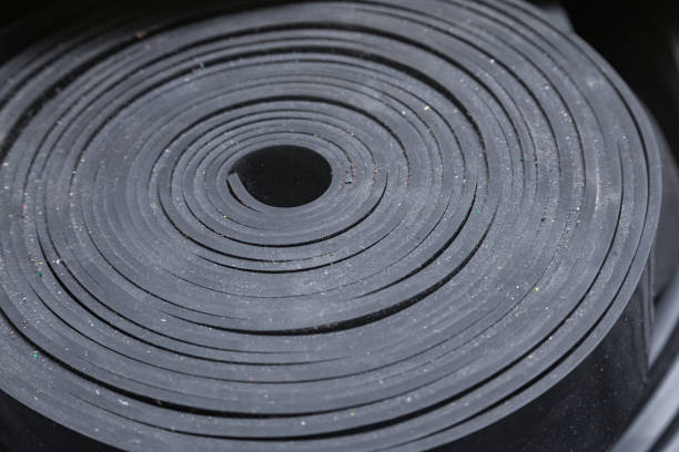 istock Industrial, new, black rubber twisted into a roll, close-up. 1472596946