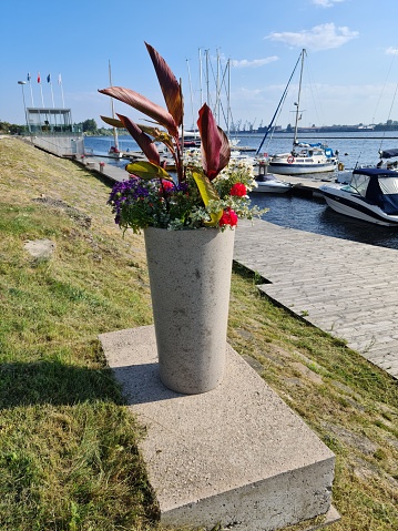 Flowers in large stone vases on the riverbank in the Latvian capital Riga in July 2021.