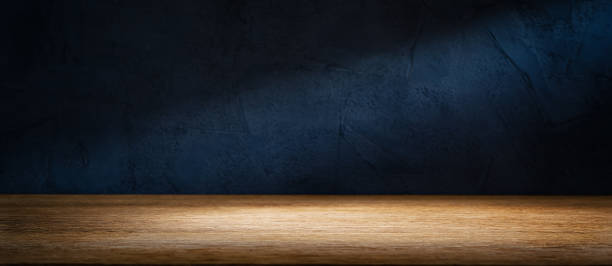 istock Wooden table or counter top with black stone wall background 1472604787