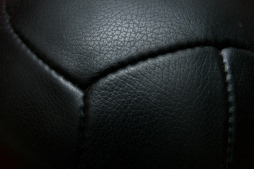 Close up black vintage football with seam