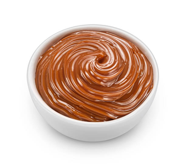 istock Melted caramel cream isolated on white background, full depth of field 1472605838