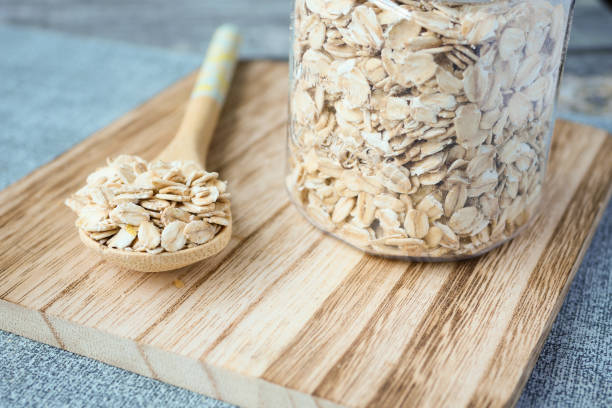 istock Close up of roasted oats flakes on spoon on table 1472606302