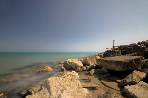 istock Seascape with cliff and old abandoned lighthouse 1472606338
