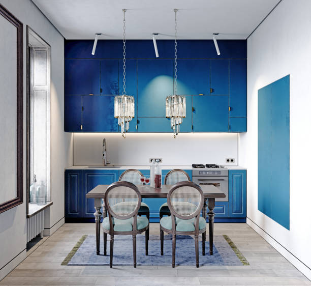 Modern classic kitchen with black dining table and chairs and light blue kitchen furniture and white walls.