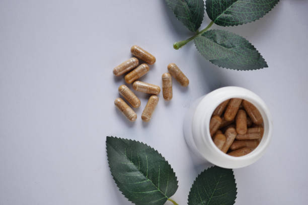 istock top view of herbal medicine capsule dropping on white 1472608712