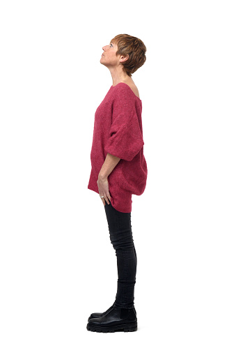 side view of a woman standing and looking up on white background