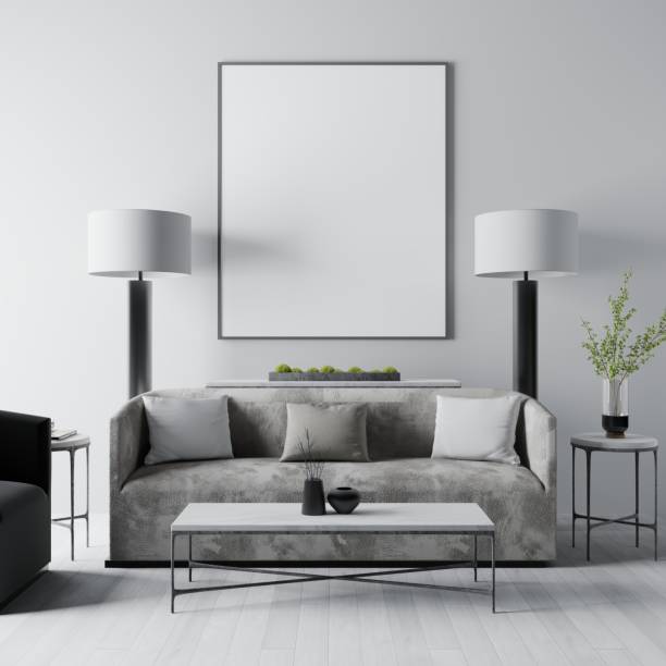 istock An empty blank on the wall above a white sofa with two bedside tables with lamps from the front view. 1472609175