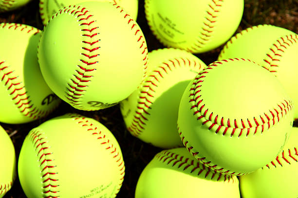 Softballs Pile of softballs on a field base sports equipment photos stock pictures, royalty-free photos & images