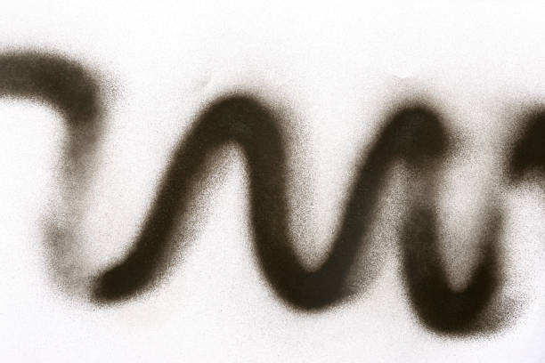 wavy line of black spray paint on white paper background