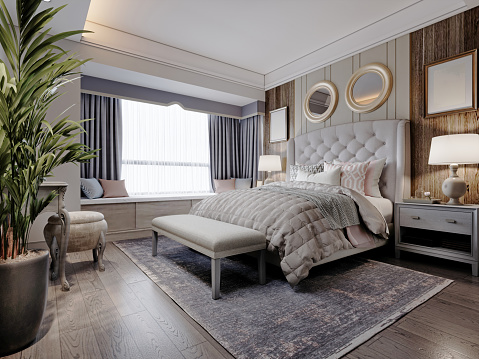 American design bedroom with white large bed with quilted headboard with wall paneling and dark wood parquet. 3d rendering.