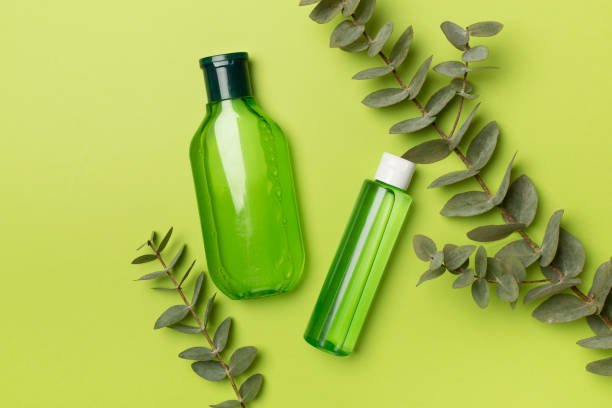 istock Cosmetic bottle with eucalyptus branch on color background, top view 1472617288