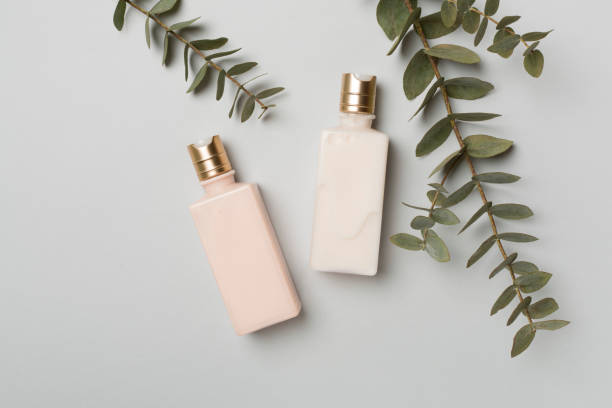 istock Cosmetic bottles with eucalyptus branch on color background, top view 1472617290