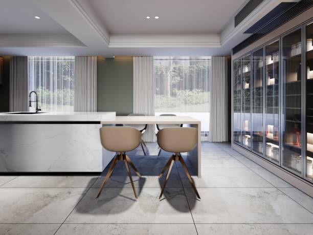 istock Side table to the kitchen island with designer chairs in a contemporary style kitchen with green walls. 1472617530