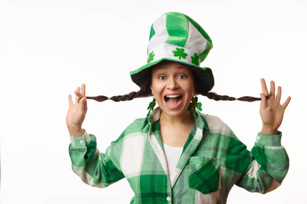 Mid adult woman celebrating, white background.