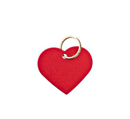 Closeup of a red metal heart-shaped tag with clipping path.  Blank for your text.