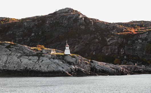 Norwegian coastal landscape with small lighthouse tower on a seacoast