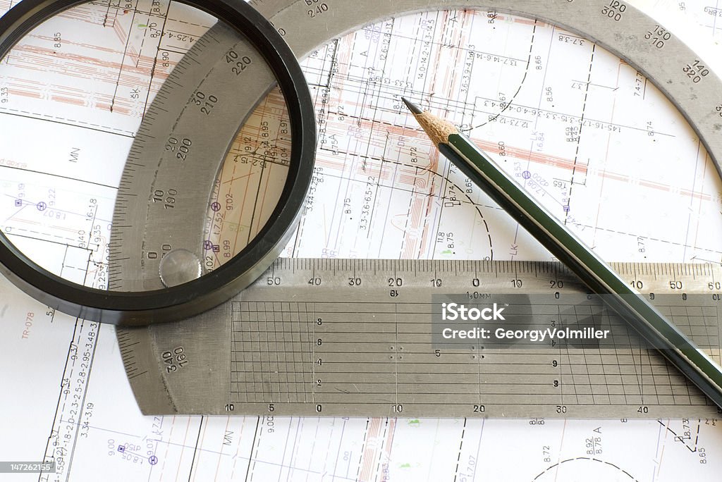 blueprint with pencil, loupe and steel protractor Engineering digital color blueprint with pencil, loupe and steel protractor Authority Stock Photo