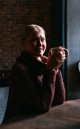 Woman Drinking Herbal Tea in Cafe