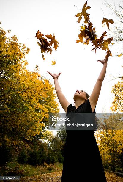 Girl Throwing Leaves Into The Air Stock Photo - Download Image Now - Achievement, Active Lifestyle, Autumn