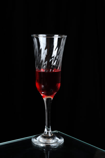 istock glass goblet with red drink isolated on black background 1472632035