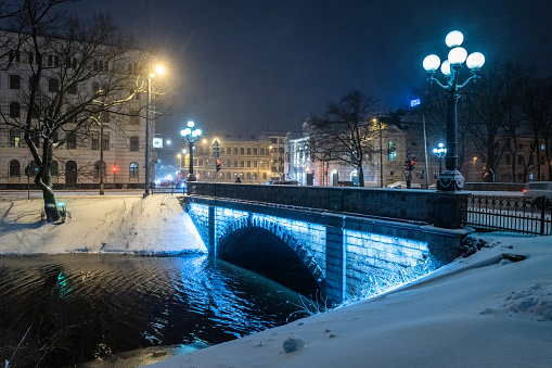 Bastejkalns Park at night in a snowfall.