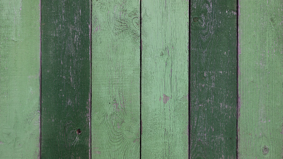 Green old painted wooden background.