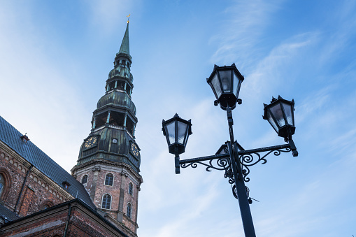 Ancient lanterns in Old Riga. St. Peter's Church can be seen in the distance