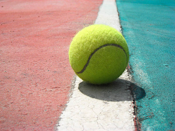 istock Yellow tennis ball on the old courte 147263810