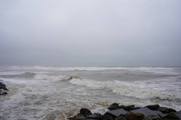 istock View of stormy ocean water fronts with waves breaking on rocks 1472640471