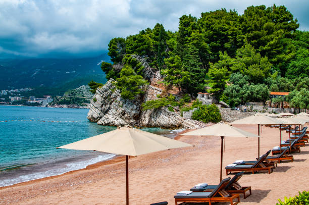istock A beach with lounge chairs and umbrellas on the sand 1472640824