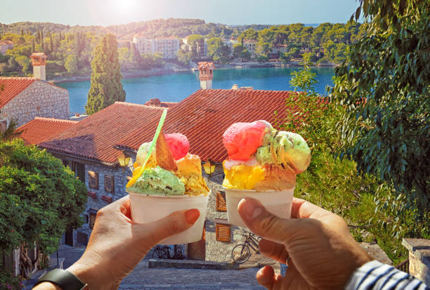 Couple with beautiful bright sweet ice cream of different flavors in the hand stock photo