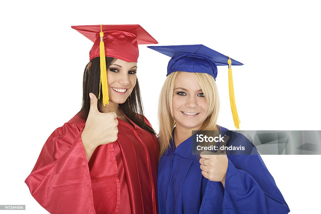 Graduation Beautiful Caucasain girls in graduation gowns and smiling Achievement Stock Photo